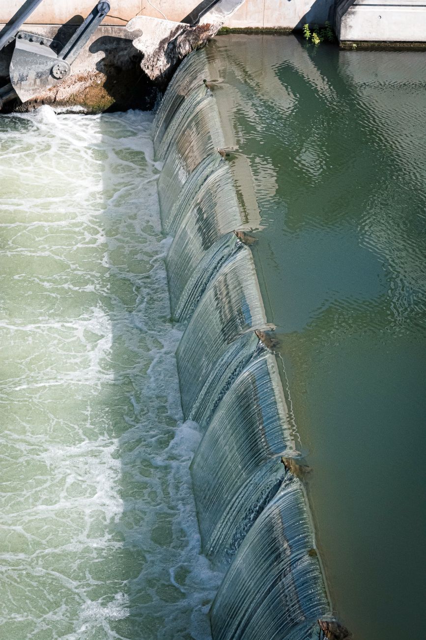 A water-control gate directs flowing water through a channel.