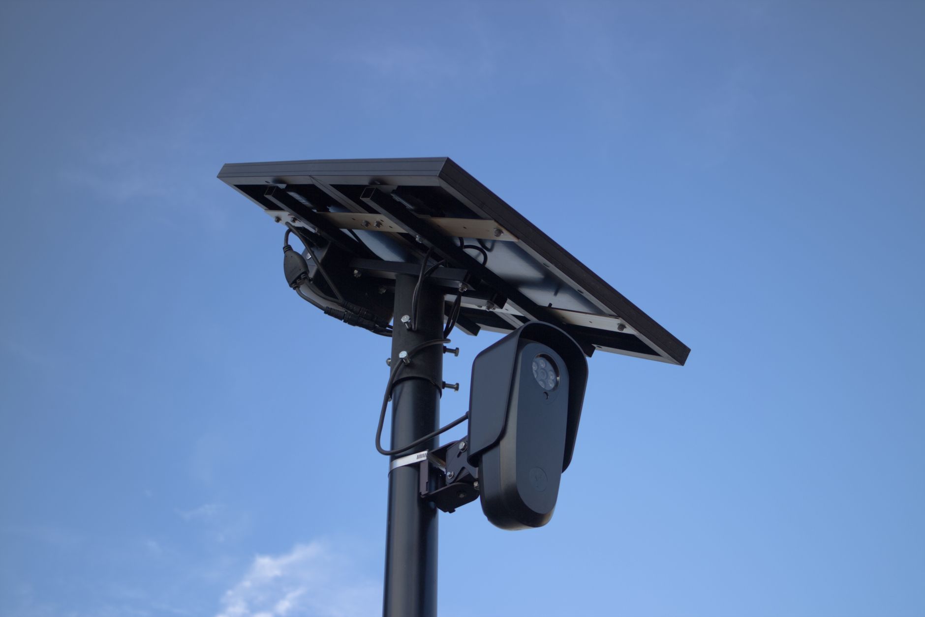 A solar-powered surveillance camera mounted on a pole.